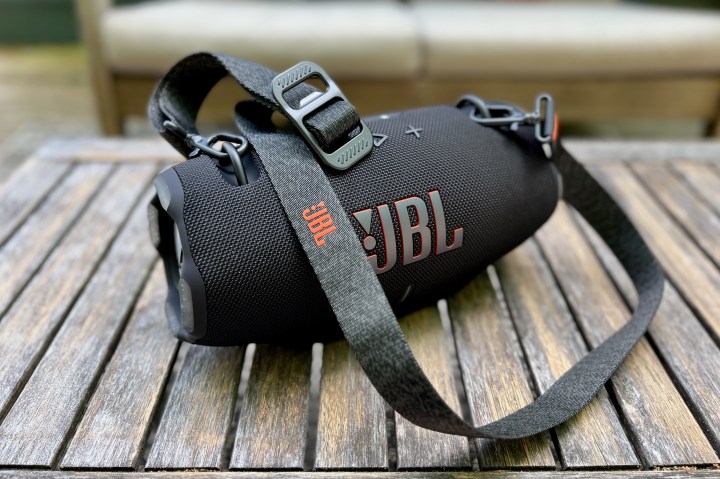 The JBL Xtreme 4 Bluetooth speaker on an ooutdoor table.